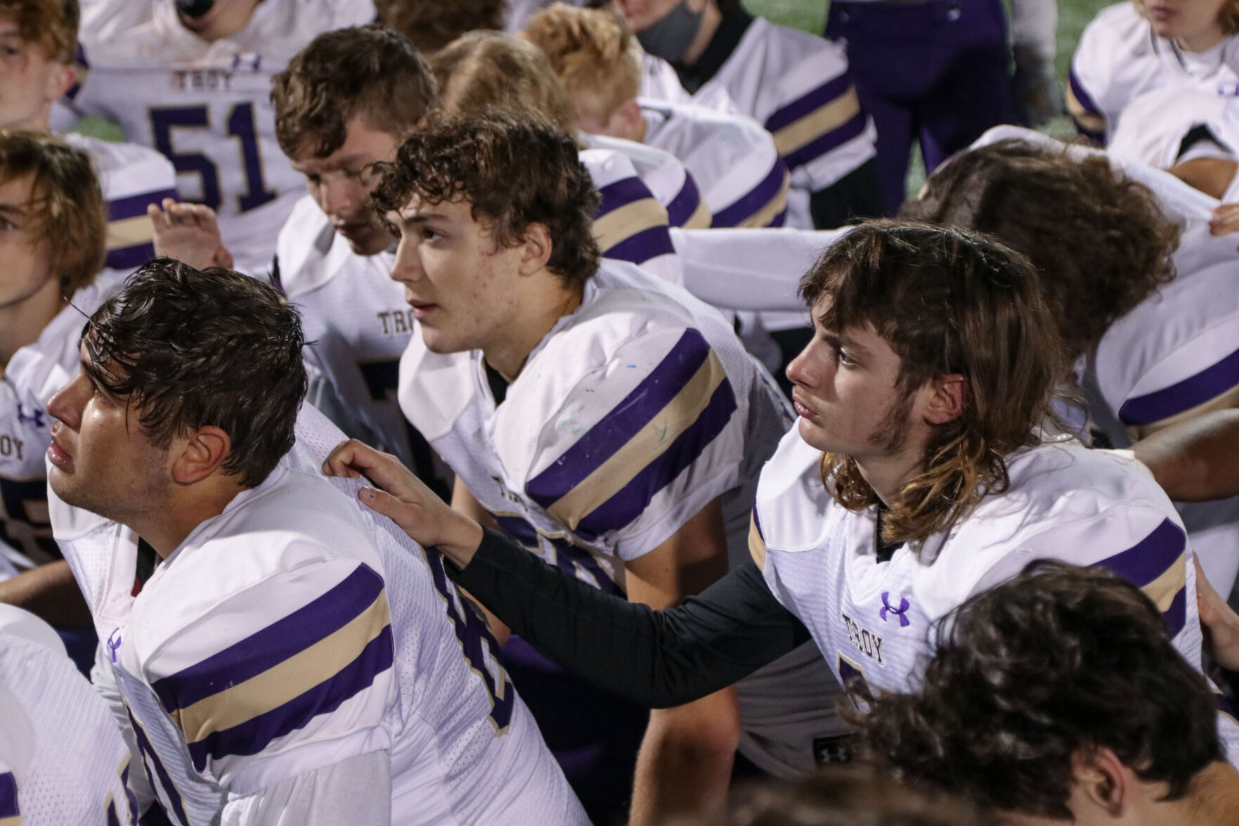 The Troy Buchanan Trojans listen to their coach after being eliminated